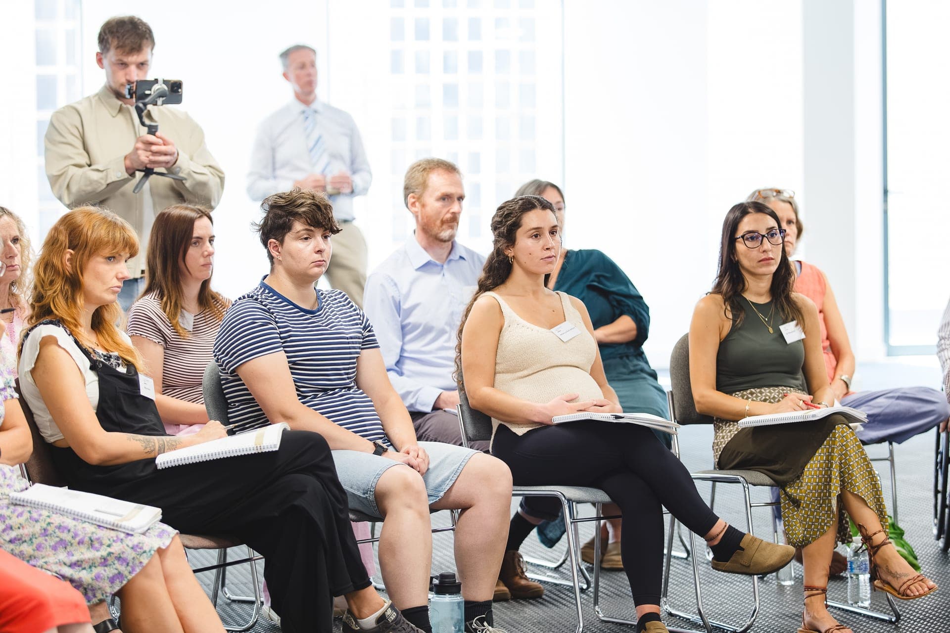 Delegates with notebooks during an accredited EMDR training day, filmed from the back of the room